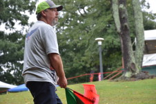 Newton readies himself to wave the green or red flag while spotting on Hole 18 on Friday